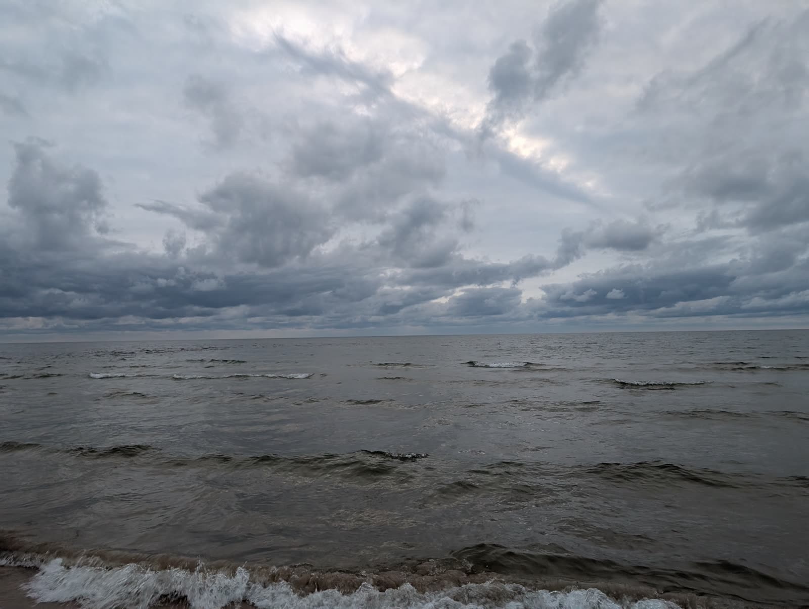 Overcast Lake Michigan, dramatic gray clouds over steel-colored water